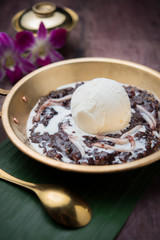 Coconut milk ice cream on brass blow with thai sweet sticky rice