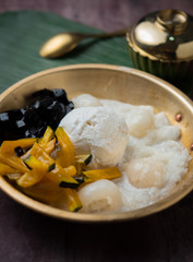 Coconut milk ice cream on brass blow with Thai Desserts and grass jelly