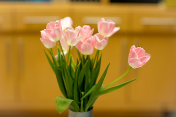 Bouquet of  pink tulips on wooden table.