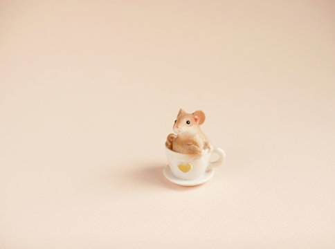 toy small mouse on pink background. Copy space for text.
