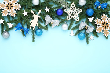 Christmas tree branches with toys on blue background