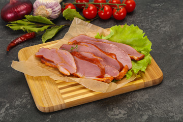 Sliced smoked duck breast served salad