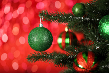 Christmas fir tree with ornaments on blurred lights background