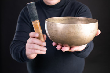 tibetan singing bowls with man hands black clothes