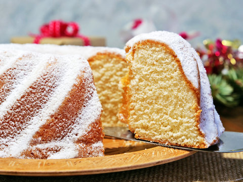 Vanilla bundt cake sliced, gugelhupf closeup on wooden platter
