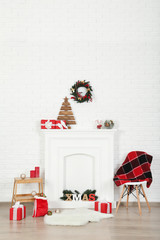Decorated fireplace for christmas near brick wall at home