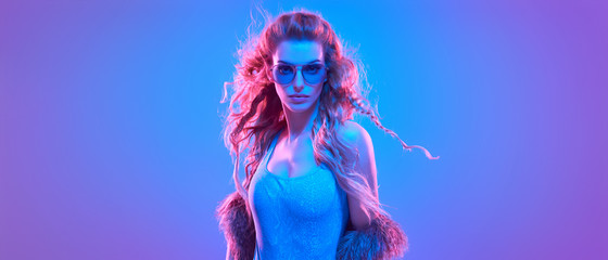 High Fashion. Party disco girl with pink neon hairstyle dance. Sensual woman in Colorful uv Light....