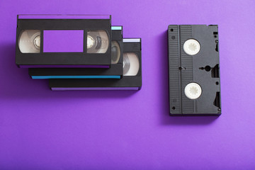 Video cassette on violet background.