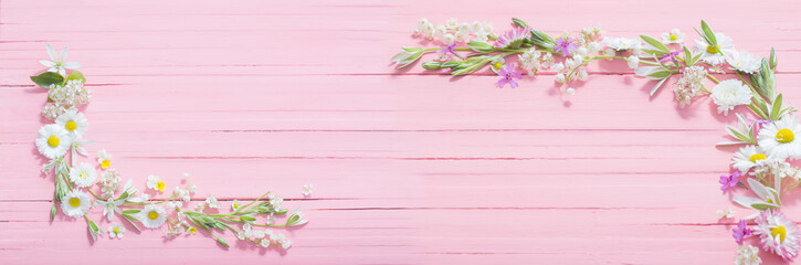 Naklejka na ściany i meble beautiful flowers on pink wooden background