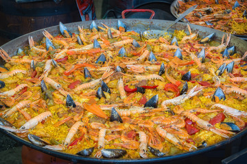 Traditional Spanish paella with chicken, seafood and vegetable ingredients.