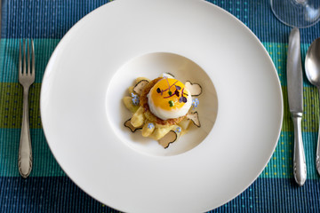 Fine dining poached egg with white asparagus, truffles and béarnaise sauce