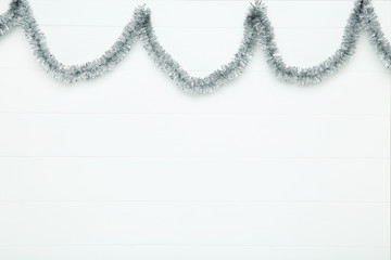 Christmas tinsel on white wooden table