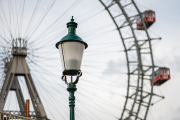 Fototapeta na wymiar Lamp in front of Wiener Riesenrad on a cloudy day in winter