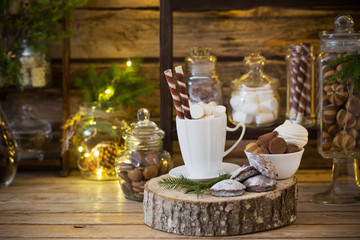 Christmas decoration cocoa bar with cookies and sweets on old wo