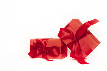 wo red gifts with red ribbons on a white background copy space for the congratulations of Christmas, New Year, Valentine's Day