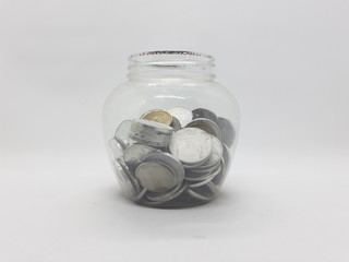 Various Valuable Indonesian Rupiah Money Coins Personal Saving within Transparent Plastic Jar in White Isolated Background