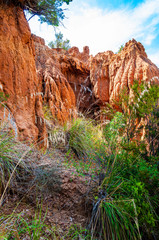 High red clay rocks and cliffs washed by winter rains and surface water flows. Clay quarry, mines...