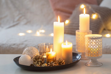Christmas decoration   with burning candles on  white table agai
