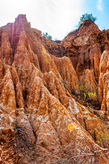 High red clay rocks and cliffs washed by winter rains and surface water flows. Clay quarry, mines...