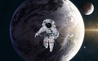 Obraz na płótnie Canvas Astronaut in outer space in orbit of the planet Earth in warm light of Sun. Moon. Solar system. Science fiction. Elements of this image furnished by NASA