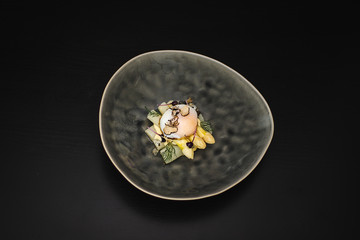 Fine dining poached egg with white asparagus, truffles and béarnaise sauce