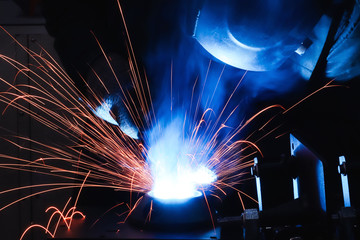 welder performs welding work on a semi-automatic welding machine