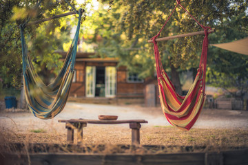 Cozy Backyard with hammocks and a work shed in the background.