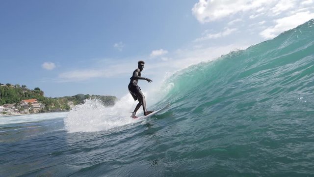 Footage of a surfer making a turn on a wave. Shot in 4k.