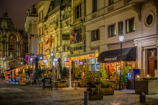 Night view with small street terraces with tourists, Bucharest, Romania