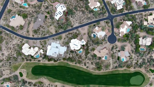 Aerial view above golf course and upscale luxury homes in Scottsdale, Phoenix, Arizona