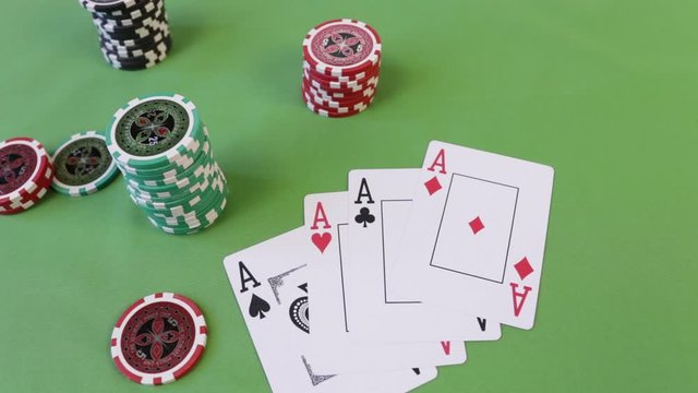 Male hand puts four aces on a poker table. Cards and chips on a green casino table. Combination of 4 aces or square poker background with copy. Big bet with a bundle of cash. Russian cash rubles. 1000