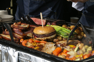 Street food hamburger top on meat and vegetables