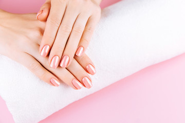 Beautiful Woman Hands . Spa and Manicure concept. Female hands with pink manicure. Soft skin skincare concept. Beauty nails. Over beige background