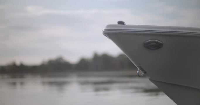 Close up of motor boat front bow as it gently floats in still water