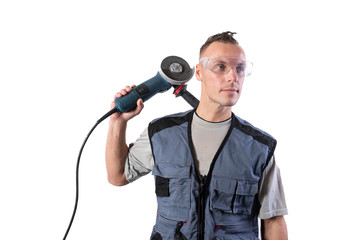 Builder in safety glasses with angle grinder on his shoulder.