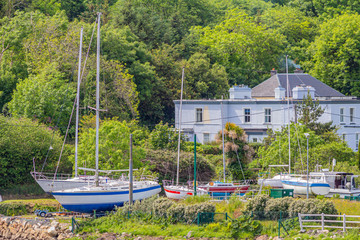 Boats out of the water in the port of Clifden next to the pier, sunny spring day in the province of Connacht, Ireland