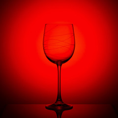Empty wine glass on red background
