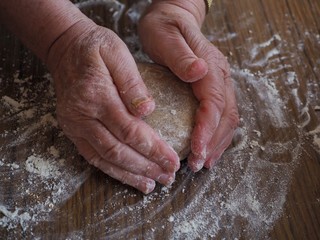 Fototapeta premium Senior womans hands kneading gingerbread dough 