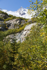 Dombay mountains, trekking in national park to the Alibek waterfall and glacier, autumn landscape