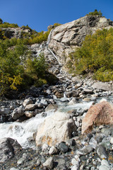 Dombay mountains, trekking in national park to the Alibek waterfall and glacier, autumn landscape