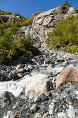 Dombay mountains, trekking in national park to the Alibek waterfall and glacier, autumn landscape