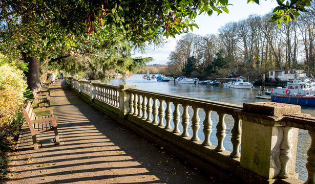 Path beside the River Thames at Twickenham, London UK, photographed in strong sun on a fine winter's day.