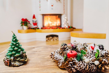 Christmas decorations in living room with burning fireplace 