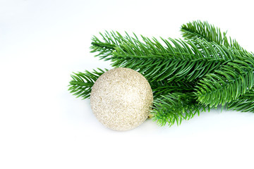 Christmas tree branch and golden balls on a white background. Elements of the Christmas composition. Christmas and New Year's decor.