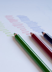 Colour drawing  pencils and colourful curved lines on a white paper