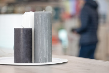 New candles on a market stall in the shop background.