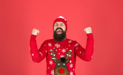 I am winner. Buy festive clothing. Sweater with deer. Hipster cheerful bearded man wear winter sweater and hat. Happy new year. Join holiday party craze and host ugly christmas sweater party