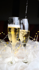 New Year Eve toast to 2026 pour champagne glasses or sparkling wine with splashing champagner.	