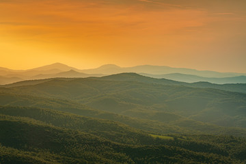 Fototapeta na wymiar Beautiful sunset over the hills near Montalcino. Travel destination Tuscany, Val d'Orcia, Italy
