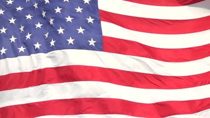 SLOW MOTION CLOSE UP: American flag waving proudly in the wind, representing. United States of America on a sunny day. USA flag fluttering in summer breeze